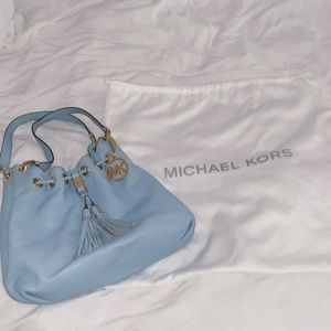 A baby blue Michael Kors purse.
